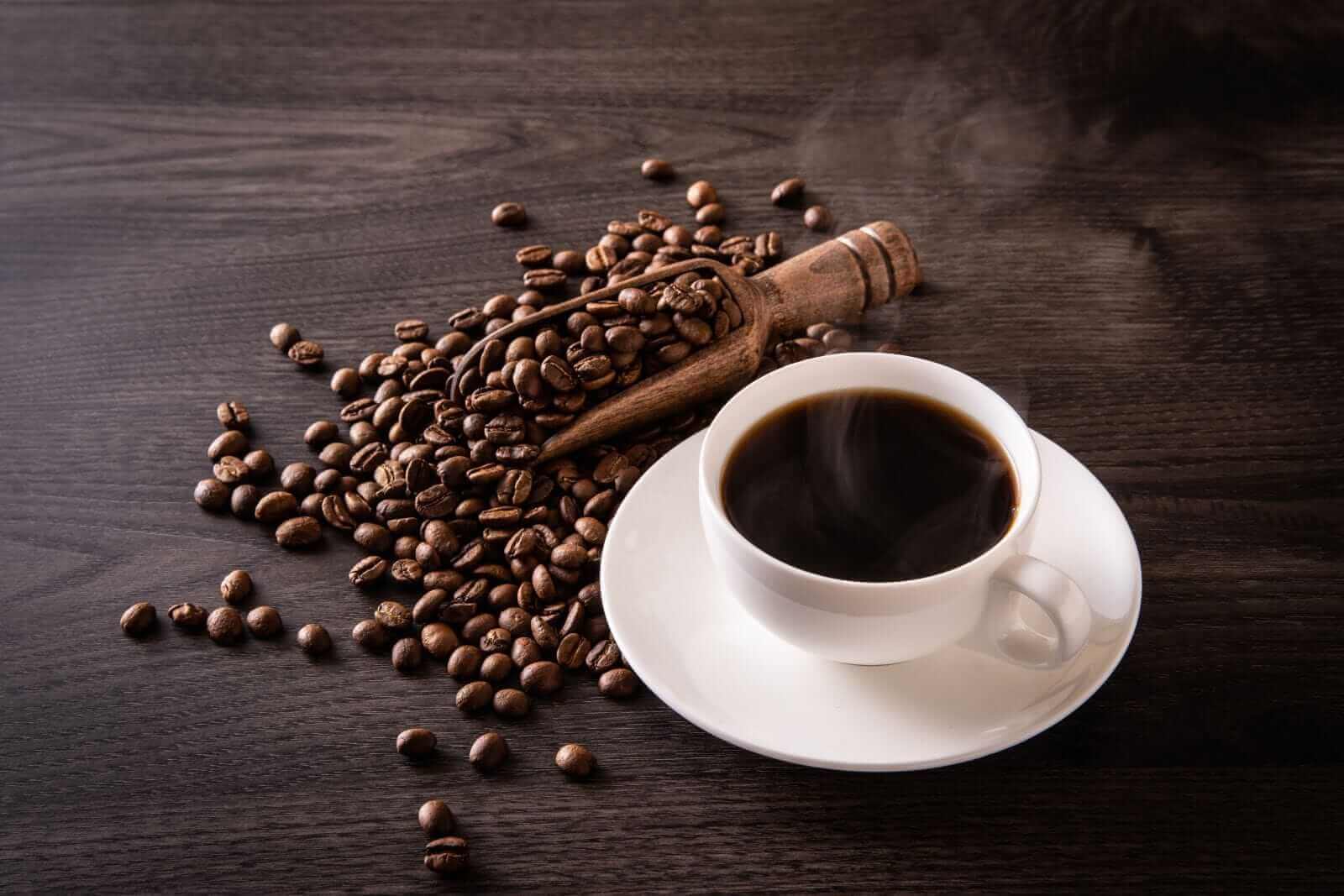 Reading Coffee Shop -Reading Coffee Shop Coffee beans and hot coffee on the table by Jazz3311 via Shutterstock
